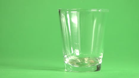 Tequila-pouring-on-a-glass-on-a-chroma-background