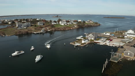 Aerial-panorama-of-boat-returning-to-northeastern-quiet-coastal-town