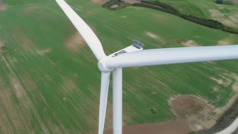 Rotor-Blades,-Nacelle,-And-Tower-Of-Wind-Turbines-Stands-Against-The-Green-Fields-In-Kwidzyn,-Poland