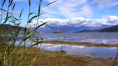 Prespa-lake-with-Maligrad-island-surrounded-by-water-and-mountains-in-Balkans