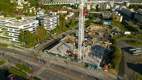 Build-Of-House-showing-construction-site-in-Gdansk-with-big-crane-and-Workers-Working-during-sunny-day