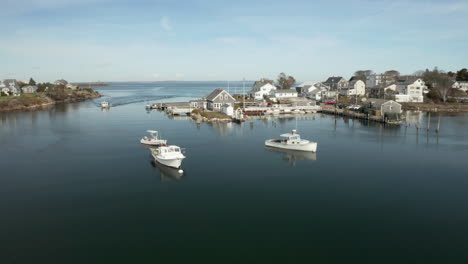 Coastal-fishing-village-with-boats-in-large-tide-pool,-drone-shot
