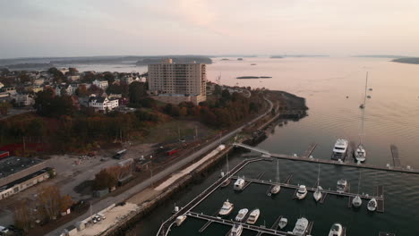 Drone-shot-above-marina-in-Portland-Maine,-morning-soft-light