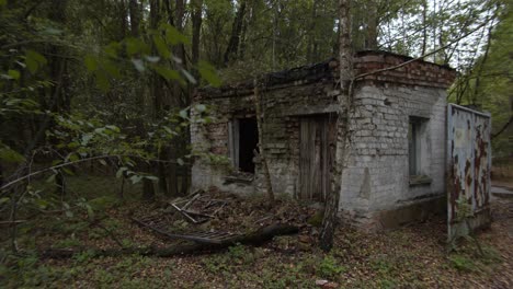 An-abandoned-brick-shed-by-the-forest-in-Prypiat,-Chernobyl--wide