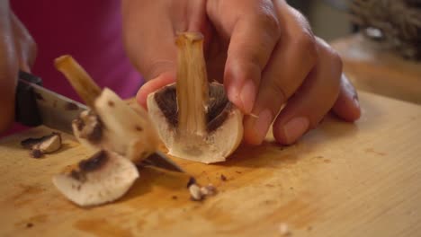 Hands-slicing-mushrooms-on-a-cutting-board