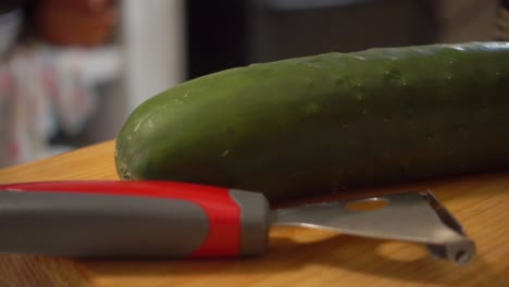 Cucumber-and-peeler-on-a-cutting-board