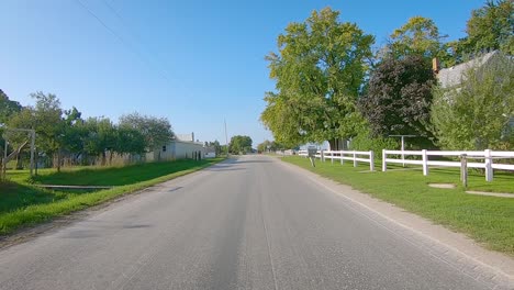 POV-driving-on-a-rural-road-approaching-a-horse-and-buggy-in-Iowa-Amish-country---Kalona,-Iowa