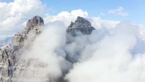 Aerial-drone-Mountain-Top-Range-peaks-in-white-clouds