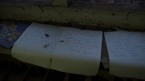 Torn-Notebook-Pages-With-Hand-Writing---Chernobyl-Disaster---Pripyat,-Ukraine---handheld-shot
