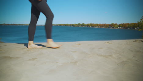 Woman-walking-on-a-sandy-beach-in-autumn