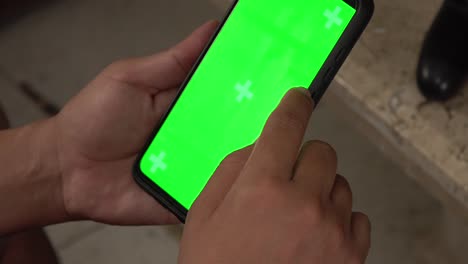 A-smartphone-user-taping-on-a-chroma-screen