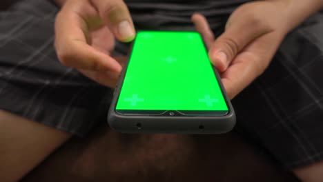 Frontal-view-of-hands-taping-on-an-smartphone-chroma-screen