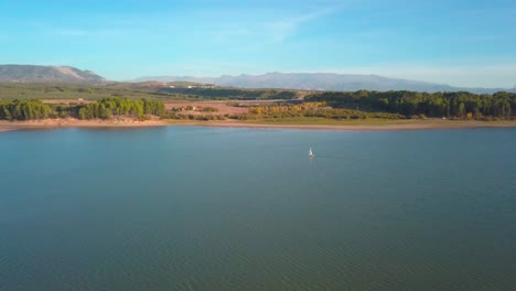 Aerial-view-of-a-sailing-boat-in-a-lake-of-the-south-of-Spain-on-a-sunny-day