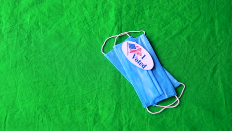 Rackfocus-blue-surgical-masks-with-I-Voted-Stickers-on-green-screen