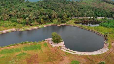 UHD-drone-shot-birds-eye-view-picnic-spot-by-the-lake-over-the-mountain-jungle