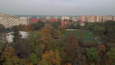 Aerial-sideways-dolly-along-football-field-and-blocks-of-flats-in-Melnik,-Czech-Rebuplic