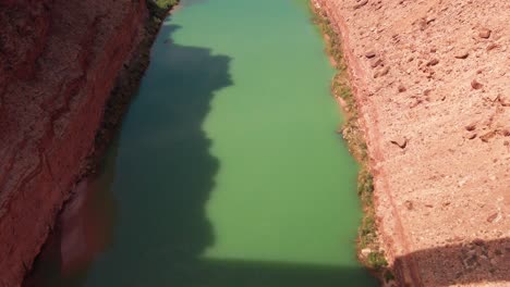 Tilting-up-shot-above-the-Colorado-River-to-reveal-Navajo-Bridge-at-the-Mouth-of-the-Grand-Canyon