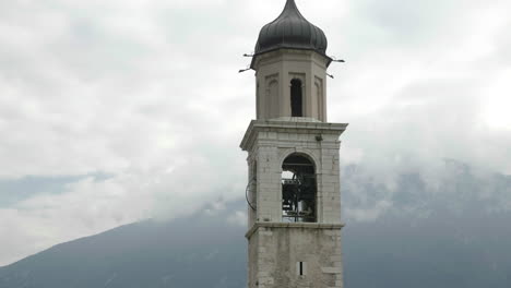 Close-up-shot-of-bells-tolling-in-the-Saint-Benedetto-Church-tower-near-Garda-Lake,-Italy