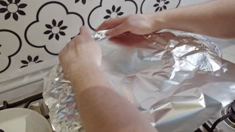 Covering-hot-pot-with-indian-biriyani-rice-with-foil-paper