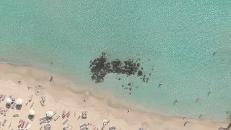 Clear-blue-sea-water-at-nissi-beach---Zoom-out-Aerial-View