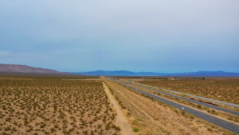 Highway-stretching-through-the-desert-landscape-in-this-dynamic-pull-back-aerial-hyperlapse