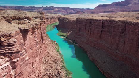 Slow-tilting-up-shot-of-the-Colorado-River-through-a-narrow-desert-canyon