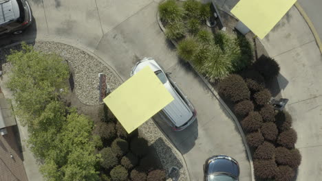 Drone-aerial-flyover-of-cars-in-line-at-a-fast-food-restaurant-drive-thru-during-COVID-pandemic