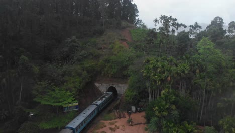 Train-crossing-Nine-Arches-Bridge-and-enters-tunnel-in-foggy-morning-at-Ella-Sri-lanka