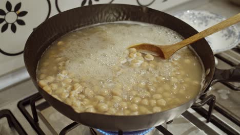 Chickpeas-boiling-in-hot-water-inside-a-cooking-pan
