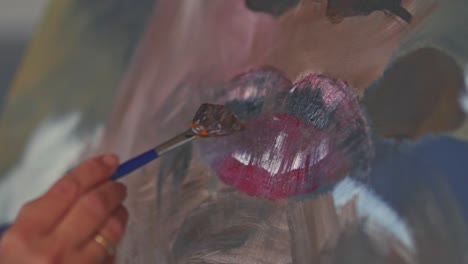 Female-hands,-painting-lips-with-a-small-painting-brush-in-slow-motion