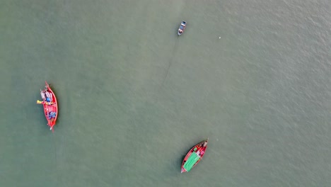 Aerial-view-of-the-fishing-boats-on-tropical-sea-coast-with-sandy-beach-at-sunset