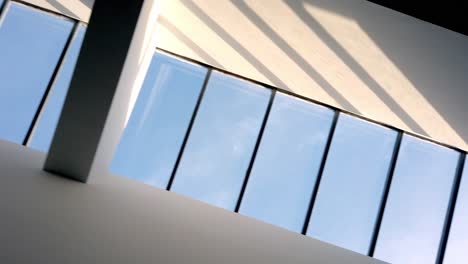 Abstract-shot-looking-up-at-sky-light-window-in-modern-building-2