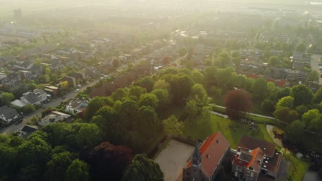Suburban-Rotterdam-residential-real-estate-neighbourhood-trees-greenery-aerial-view-rising