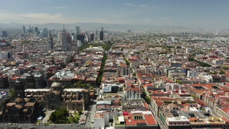 Truck-Left,-Zocalo-in-Mexico-City,-Birds-Eye-View-Skyscrapers-in-Background