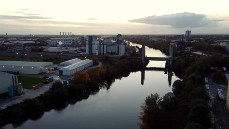 Industrial-Manchester-during-sunset,-sunrise-horizon-over-water