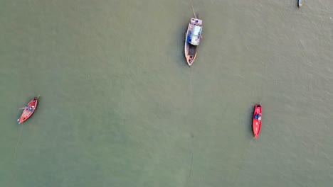 AERIAL-Top-down-shot-of-Asian-Fishing-Boats-in-shallow-water-on-the-ocean-coast