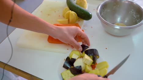 Chopping-Various-Vegetables-On-Cutting-Board-In-Kitchen---high-angle,-close-up
