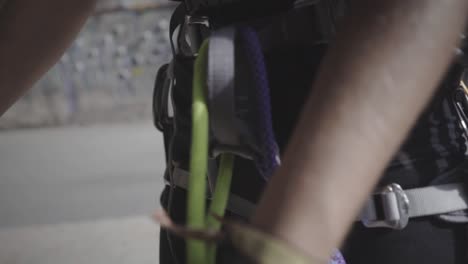 Securing-rock-climbing-ropes-with-carabiner-close-up
