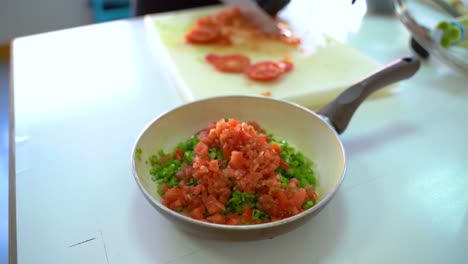 Chopped-Tomatoes-And-Leeks-In-A-Pan-On-The-Table---selective-focus