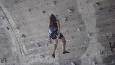 Fearless-adventurous-young-woman-rock-climbing-at-La-Foixarda-Barcelona