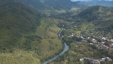 Drone-aerial-view-of-a-beautiful-green-landscape-with-a-river-near-lanquin-area-in-Guatemala,-central-america