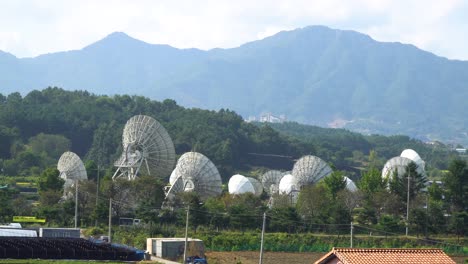 KT-SAT-Satellite-Dishes-In-Kumsan-over-big-mountains,-South-Korea-At-Daytime---static-shot