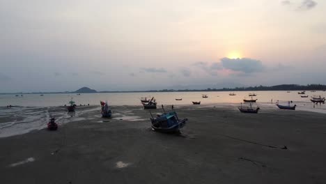 AERIAL:-Cute-Fishing-Boats-stranded-at-low-tide-on-the-coast-at-Dawn