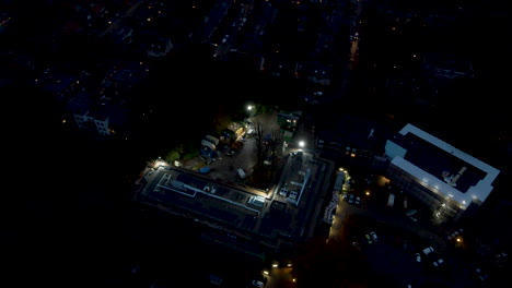 Aerial-overview-of-construction-site-with-bright-lights-at-night