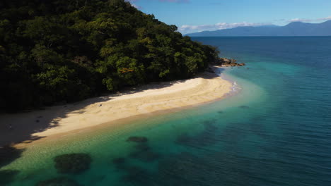 Rotating-drone-shot-of-Fitzroy-Island-Nudey-beach-in-Queensland,-Australia