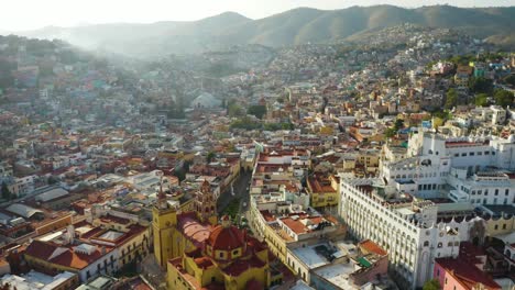 Drone-Flies-Above-Guanajuato-City-Center-in-Mexico-during-Daytime:-Catholic-Church,-University-Buildings