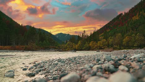 4K-UHD-Cinemagraph---seamless-video-loop-of-a-mountain-river-in-the-Austrian-alps-with-a-vibrant-evening-sky,-close-to-the-German-border-in-autumn