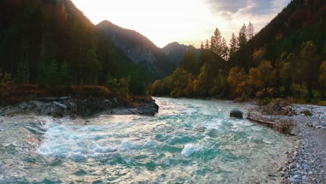 4K-UHD-seamless-anamorphic-cinema-ratio-video-of-a-mountain-river-in-the-Austrian-alps-with-a-vibrant-evening-sky,-close-to-the-German-border-in-autumn