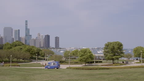 Slow-pan-over-Ivy-Lawn-in-Chicago-with-Lake-Michigan-and-beautiful-city-skyline-on-horizon-on-a-sunny-summer-day