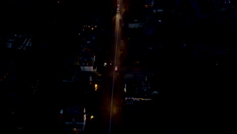 High-angle-of-traffic-driving-over-suburban-street-at-night